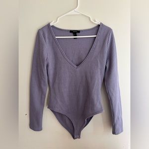 A purple low cut bodysuit from forever 21.